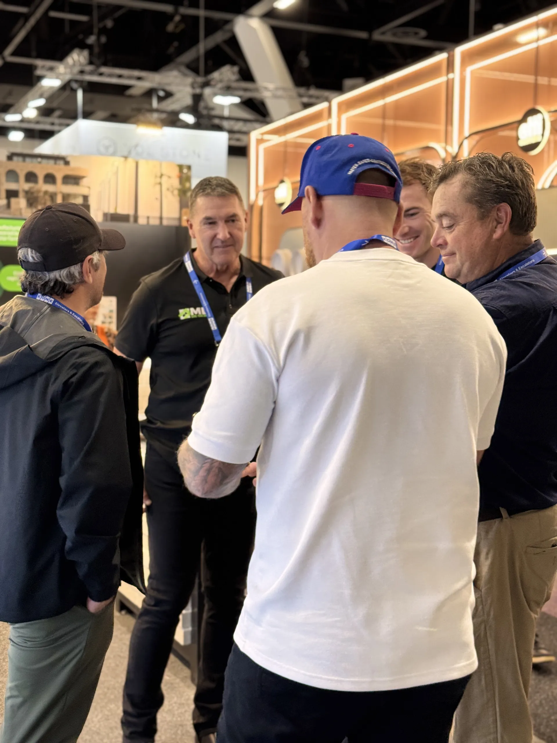 Builders and industry partners networking at a construction trade expo stand