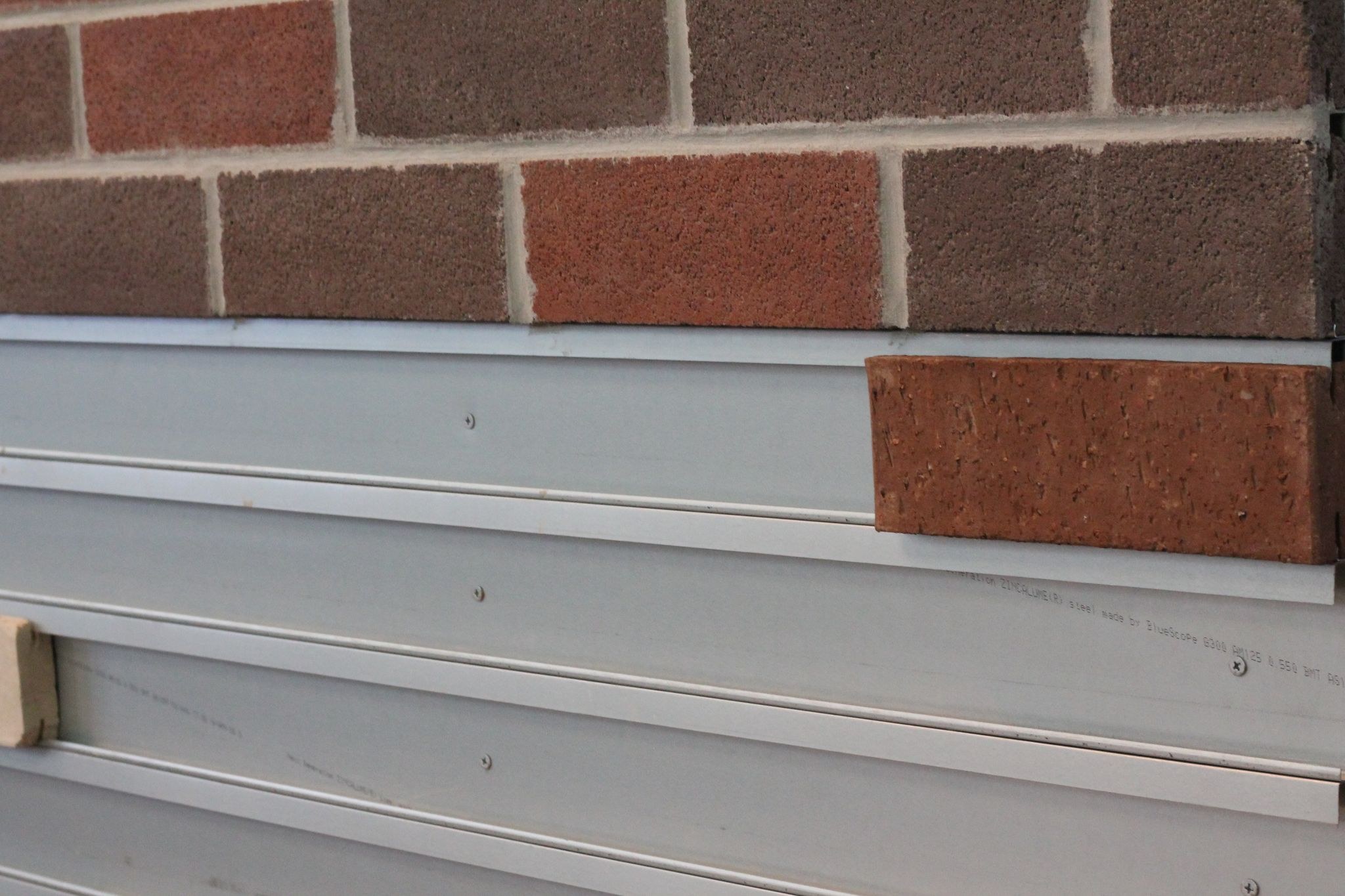 The exposed rail and brick facings on the display wall