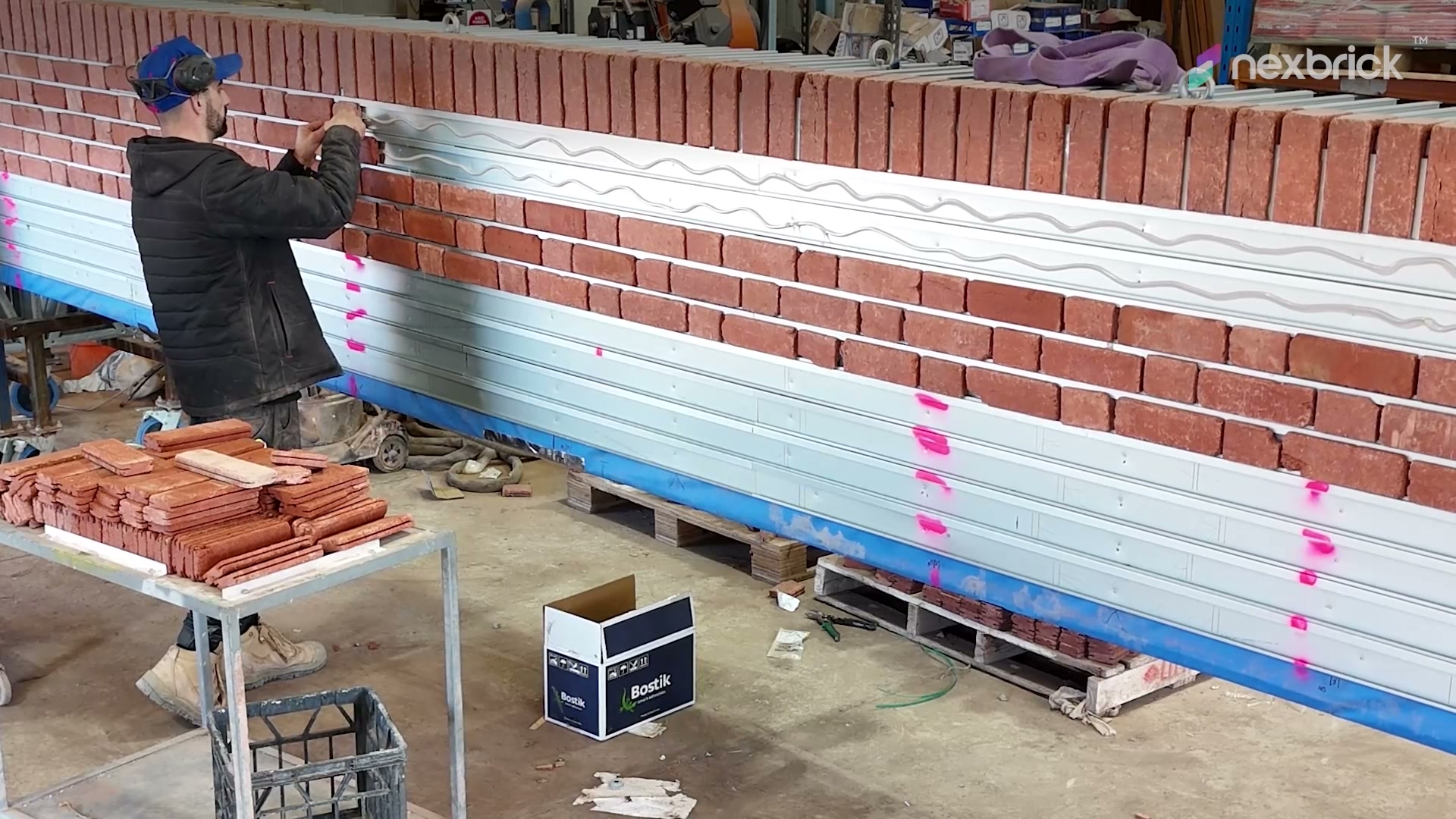An installer fitting brick facings into the rail system